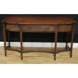 A 19th century mahogany shaped break-centre serving table, slightly oversailing top above three