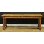A 19th century pine coaching inn table, oversailing top, turned legs, H-stretcher, 75.5cm high,