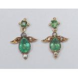 A pair of emerald and diamond droplet earrings, each with a central pear drop emerald approx 11mm