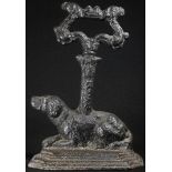 A Victorian cast iron door stop, as a recumbent dog, posted leafy loop handle, 21.5cm high, c.1850