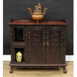 A Chinese hardwood side cabinet, shallow three gallery above a pair of rectangular doors and niches,
