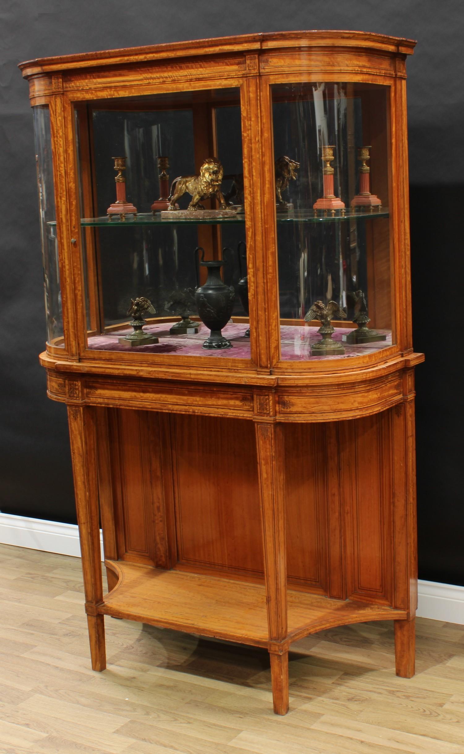 A Sheraton Revival satinwood connoisseur's display cabinet on stand, moulded cornice above a