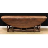 An 18th century style oak wake table, in the Irish manner, oval top with fall leaves, turned legs,