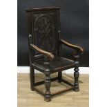 A 17th century style oak wainscote armchair, rectangular panel back carved in relief with a stylised