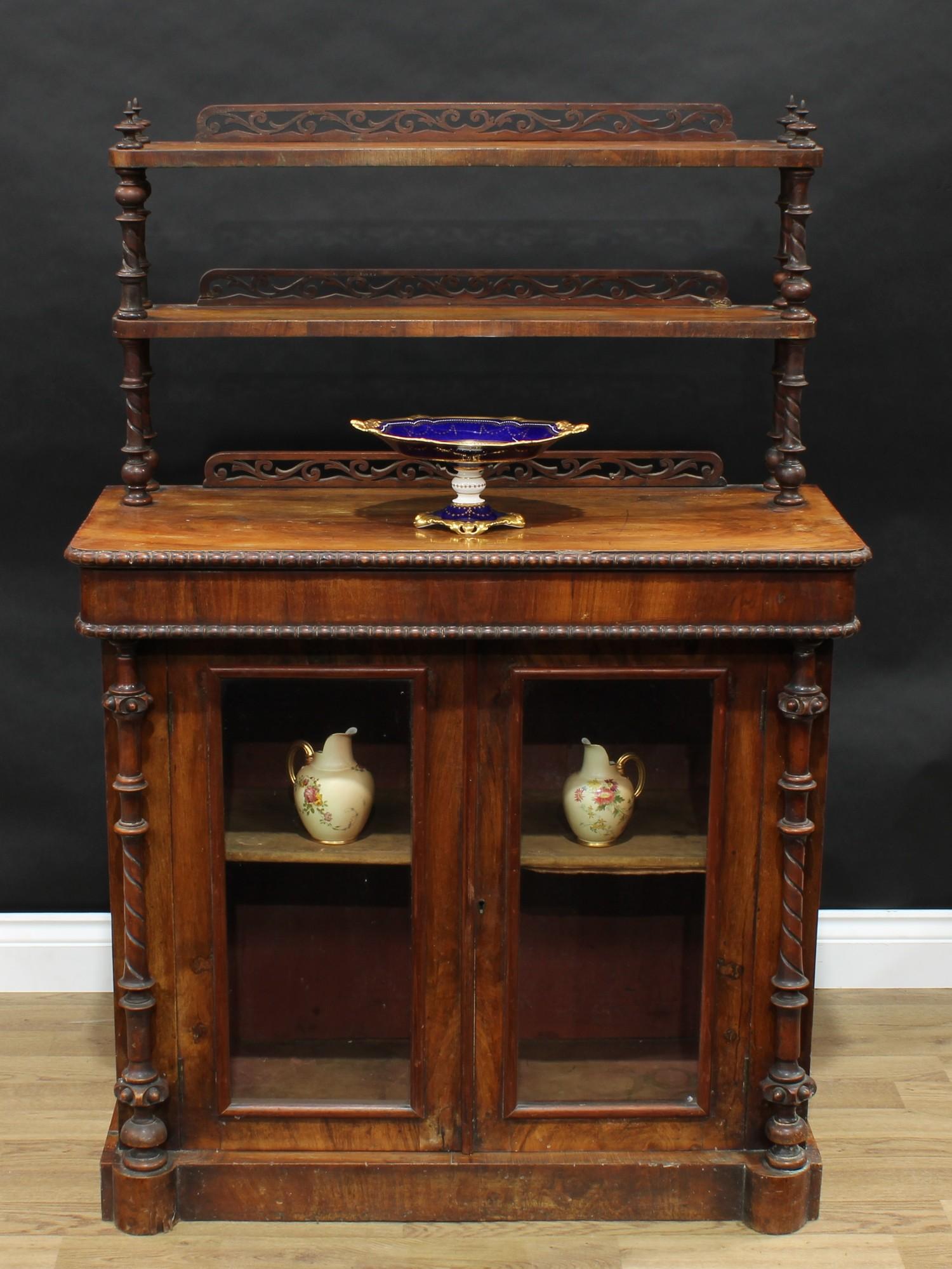 A Victorian walnut pier cabinet, rounded rectangular superstructure with two shelves, flanked by