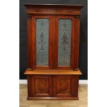 A Victorian walnut bookcase, dentil cornice above a pair of rectangular doors, the glass etched in