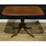 A Regency mahogany rounded rectangular breakfast table, moulded tilting top, turned pillar, hipped