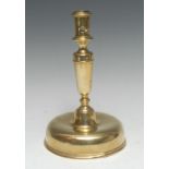 A mid-17th century brass candlestick, cylindrical sconce, domed spun base, 23.5cm high, c.1650