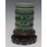 A Chinese monochrome scholar's bitong brush pot, of faux bamboo form and glazed in tones of