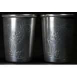 A pair of Russian silver tapered cylindrical vodka cups, each bright-cut engraved with a flowering