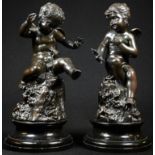 Mayer, a pair of dark patinated bronzes, scantily clad male and female putti, signed in the