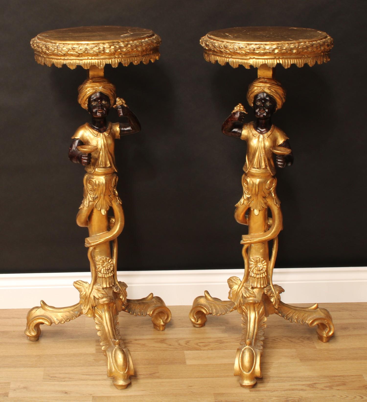 A pair of Venetian style blackamoor torcheres, each with circular plateau above a figural support,