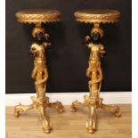 A pair of Venetian style blackamoor torcheres, each with circular plateau above a figural support,