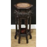A Chinese hardwood shaped circular jardinière stand, the top with inset circular soapstone panel