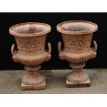 A pair of Victorian cast iron half fluted campana shaped garden urns, each in relief with a band