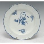 A Worcester shaped circular plate, basket weave moulded border, decorated in under glaze blue with