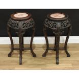 A pair of Chinese hardwood jardinière stands, circular tops with inset soapstone panels, pierced and