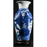 A Chinese ovoid vase, painted in tones of underglaze blue with flowers and leaves, two-part