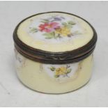 A Rococo design enamel circular snuff box or bonbonniere, painted in polychrome with country flowers