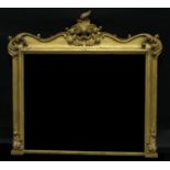 A large 19th century giltwood overmantel looking glass, rectangular mirror plate framed with applied