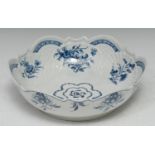 A Worcester junket dish or salad bowl, moulded in relief and painted with flowers and foliage,
