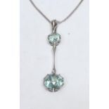 An early 20th century natural blue Zircon two stone pendant necklace, the S ring suspension hung