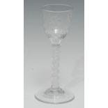 An early George III wineglass, the round funnel-shaped bowl engraved with a Jacobite carnation and a