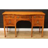 A 19th century satinwood crossbanded mahogany serpentine sideboard, slightly oversailing top above