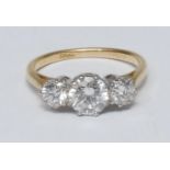 A diamond trilogy ring, central round brilliant cut diamond approx 1.03ct, flanked either side by