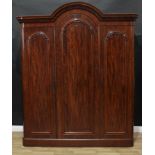 A Victorian mahogany triple wardrobe, arched cresting carved with a frieze of stylised acanthus,