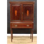 A 19th century mahogany and marquetry cabinet on stand, moulded outswept cornice above a pair of