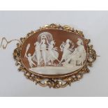 A 19th century carved shell cameo brooch, Allegorical study, unmarked gold coloured metal