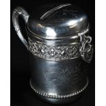 A 19th century German silver cylindrical money box, acanthus-capped scroll handle, embossed with a