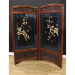 A Japanese hardwood, lacquer and shibayama two-fold dressing screen, each arched rectangular crsting