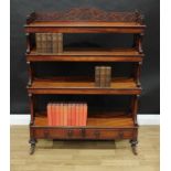 A Victorian walnut open bookcase, three-quarter fretwork gallery pierced with leafy scrolls, above