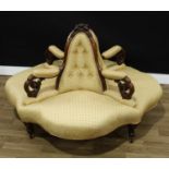 A Victorian walnut four section coversation seat, each cresting bolding carved with fruit and