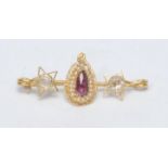 A diamond seed pearl and pinky purple stone bar brooch, central pear drop panel with single pinky