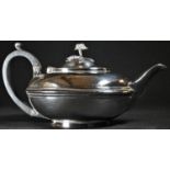 A William IV silver lamp shaped teapot, hinged domed cover with rose finial, ebonised scroll-