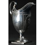 A George III silver helmet shaped cream jug, lofty scroll handle, beaded rim, bright-cut engraved