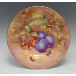 A Royal Worcester circular plate, painted by John Freeman, signed, with plums and cherries on a