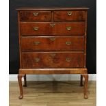 A George I walnut chest on stand, moulded crossbanded top above two short and three long graduated