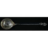 An Ottomon Turkish silver spoon, the gilt bowl engraved with Islamic script, twisted stem with