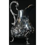 A Victorian silver ovoid cream jug, well chased with flowers and ribbon-tied leafy swags, double-