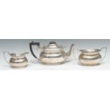 A silver three piece boat shaped tea service, gadrooned rims, angular handles, Birmingham 1928, 32oz