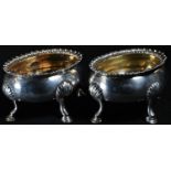 A pair of George III silver oval salts, gadrooned rims, hoof feet with shells to knees, gilt