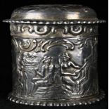 A Dutch silver cylindrical box and cover, embossed overall with pastoral figures, 3.5cm high, import