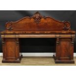 A Victorian mahogany twin pedestal sideboard, shaped back carved with scrolling acanthus, the