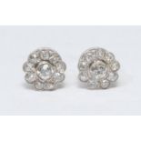 A pair of diamond floral cluster earrings, each with a central round brilliant cut diamond approx