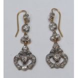 A pair of Art Deco style diamond pendant drop earrings, shaped trident heart droplets encrusted with