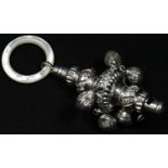 An early Victorian silver baby's rattle, embossed with flowers and stiff leaves, whistle terminal,